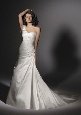 Bridal Dress: Angelina Faccenda: 1201 - Silk Shantung  Asymmetrical draping shapes the surplus, strapless gown trimmed with a flowered one shoulder strap. The corset tie back meets the chapel train. Colors Available: Natural * Please Note Shawls Are Not Included 