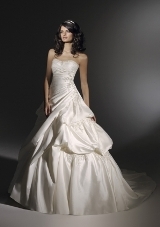Bridal Dress: Angelina Faccenda: 1202 - Silk Shantung  Swarovski crystals edge the strapless neckline with appliques trimming the asymmetrically draped bodice. A billowy waterfall skirt with an extra full chapel train. * Please Note Shawls Are Not Included 