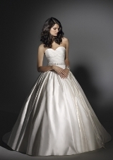 Bridal Dress: Angelina Faccenda: 1208 - Silk Shantung  Cross over draping shapes the sweetheart strapless bodice to the dropped waistline. A full shirred ball gown skirt has side pockets and an extra long chapel train. Intricate beading details the waist sash. Colors Available: Natural. * Please Note Shawls Are Not Included 