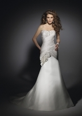 Bridal Dress: Angelina Faccenda: 1210 - Silk Shantung  Intricate embroidery overlays the strapless neckline with cross over draping, shaping the torso. Self flowers overlay the skirt on the fit and falre gown with a chapel train. Colors Available: Natural. * Please Note Shawls Are Not Included 