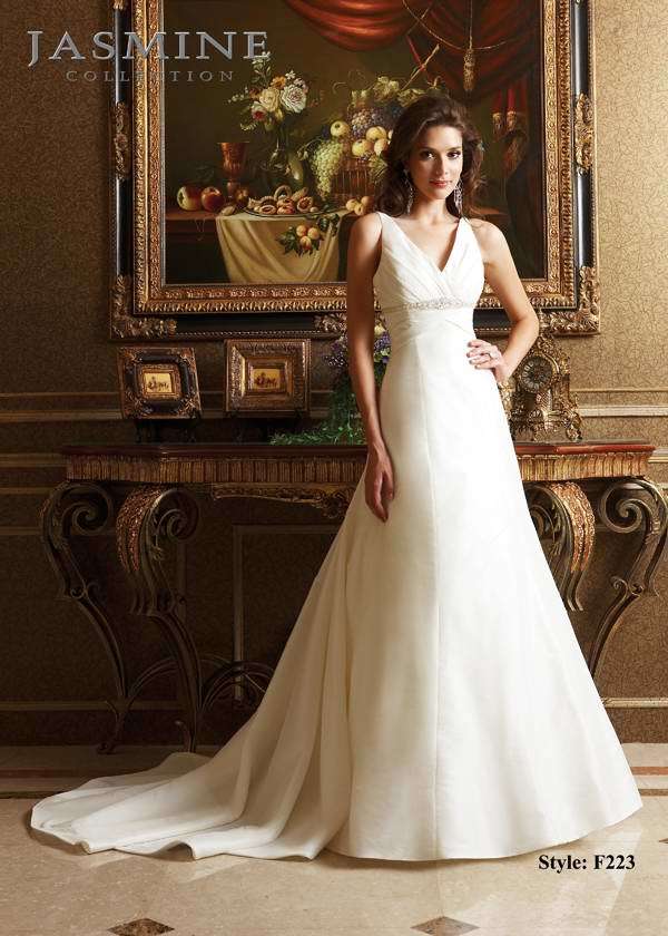 Bridal Dress: COLLECTION BRIDAL - F223  Catalogue Color:  IVORY (IV)  Silhouette:  Pleated V neckline with beading and embroidery along the front empire waist. Beaded applique at back waist with covered buttons to end of drop waist seam  Fabric-top layer:  TAFFETA  Accessory:  N/A  Skirt Length:  Tiffany Train  Size Range:   4-28  