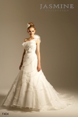Bridal Dress: COLLECTION BRIDAL - F404  Catalogue Color:		IVORY (IV)-IVORY (IV)	Fabric-top layer:		ORGANZA, TULLE and ribbon	Accessory:		Ribbon sash	Skirt Length:		Tiffany Train	Size Range: 		4-28 