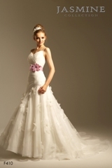 Bridal Dress: COLLECTION BRIDAL - F410  Catalogue Color:		IVORY (IV)-ORCHID (OR)	Fabric-top layer:		TULLE, ORGANZA and LUXE TAFFETA	Accessory:		Flower sash	Skirt Length:		Tiffany train	Size Range: 		4-28 