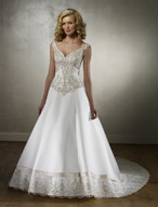 Bridal Dress: MoriLee - 2133  Beaded embroidery overlays the off-the-shoulder bodice, trimmed with peaked bands at the empire.  An A-line skirt beautifully edged with scalloped embroidery beneath a satin band that continues onto the chapel length train. Color Availability:  White/Silver, Ivory/Silver Two Tone Color: Pearl/Cafe Available in 3 Lengths:  55, 58, 61 