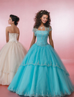 Quinceanera Dress: Quinceanera/Vizcaya: 81010 Tulle with Em  A sheer band edges the strapless neckline on the embroidered, corset seamed bodice. The scalloped edging trims the tiered overskirt and hemline of the ball gown. Matching bolero jacket is included. Color Availability: White, Ballet Pink, Aqua, Champagne 