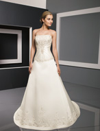 Bridal Dress: Bridals: 2301 - Duchess Satin with Embro  Strapless bodice adorned with sparkling embroidery features center draping over the bodice. The dropped waistline meets the A-line skirt with embroidery over a band surrounding the hemline and chapel length train. Available in 3 Lengths 55