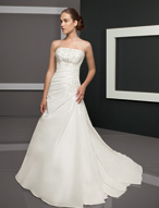 Bridal Dress: Bridals: 2308 - Radiant Taffeta with Emb  Beaded embroidery decorates the strapless bodice with asymmetrical draping cascading from the empire and crossing over the A-line shaped gown. Swarovski beaded applique trims the draping on the skirt that wraps onto the chapel length train. Colors: White/Silver, Ivory/Silver 