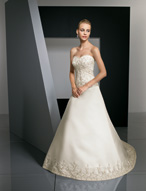 Bridal Dress: Bridals: 2318 - Duchess Satin with Embro  Sparkling embroidery overlays the strapless bodice and beads form the cross over bands at the empire. The dropped waistline meets the A-line skirt with embroidery surrounding the hemline and chapel length train. Available in 3 Lengths 55