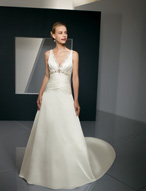 Bridal Dress: Bridals: 2320 - Satin-Faced Taffeta with  Swarovski crystals decorate the embroidery that trims the V-neckline and empire on the draped bodice. The asymmetrical draping crosses over the waist and meets the A-line skirt with a chapel length train. Colors: White/Silver, Ivory/Silver 