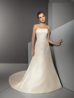 Bridal Dress: Blu: 4512 - Luxe Taffeta with Embroidery  Vertical shirring on the strapless neckline meets the asymmetrical draping from the empire over the torso with cascading embroidery onto the A-line skirt and chapel length train. Colors: White/Silver, Ivory/Silver 