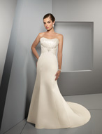 Bridal Dress: Blu: 4513 - Duchess Satin with Beaded Em  Jeweled beading decorates the embroidery on the strapless bodice with draping joining at the center of the empire on the fit and flared gown with chapel length train. Colors: White/Silver, Ivory/Silver 