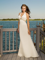 Bridal Dress: Destination/Voyage: 6304 - Silky Chiffon  V-shaped halter neckline meets the beaded trim on the peaked empire of the soft, fit and flared gown with a corset tie back closure. Matching shawl. Colors- White/Silver, Ivory/Silver Colors: White/Silver, Ivory/Silver 
