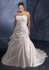 Bridal Dress: Mori Lee Julietta: 3076 - DUCHESS SATIN  The sculptured, strapless neckline has vertical draping that meets the asymmetrical draping over the fitted torso. A swirl extends from the lower hips into soft pleats onto the skirt. The corset tie back meets the soft draping on the chapel train. Colors Available: White, Ivory.* Please Note Shawls Are Not Included 