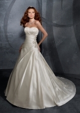 Bridal Dress: Mori Lee Blu Collection: 4704 - Duchess Satin with Embroidered Appliques  A modern traditional gown in duchess satin with crystal beading creating the applique at the side of the draped bodice. The strapless gown features soft pleasets on the full A-line skirt with a corset tie back onto the chapel train. Crystal beading decorates the waist sash. Colors Available: White/Silver, Ivory/Silver.* Please Note Shawls Are Not Included 