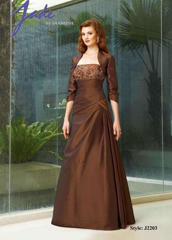 Evening Dress: JADE - J2203  Catalogue Color:  ESPRESSO (EO)  Silhouette:  Jade Taffeta gown has beaded/embroidered empire bodice with strapless neckline. Shirred drop waist and flare skirt. Matching 3/4 length sleeve jacket.  Fabric-top layer:  JADE TAFFETA  Accessory:  Jacket and detachable straps  Skirt Length:  Floor  Size Range:   2-26  