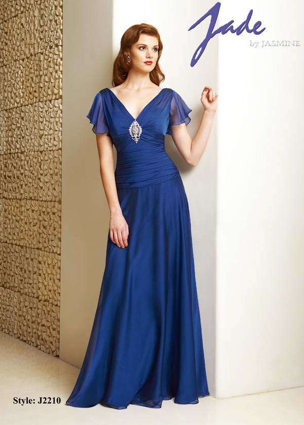 Prom Dress: JADE - J2210  Catalogue Color:  COBALT (CT)  Silhouette:  Jade Tiffany Chiffon gown has front and back V necklne with flounce sleeves. Center front bodice beaded/embroidered applique. Shirred drop waist and flare skirt.  Fabric-top layer:  JADE TIFFANY CHIFFON  Accessory:  N/A  Skirt Length:  Floor  Size Range:   2-26  