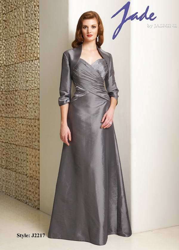 Prom Dress: JADE - J2217  Catalogue Color:  PLATINUM (PT)  Silhouette:  Jade Taffeta sweetheart neckline gown with spaghetti straps. Front criss cross shirred bodice with beading. A-line skirt and matching 3/4 length sleeve jacket.  Fabric-top layer:  JADE TAFFETA  Accessory:  Jacket  Skirt Length:  Floor  Size Range:   2-26  