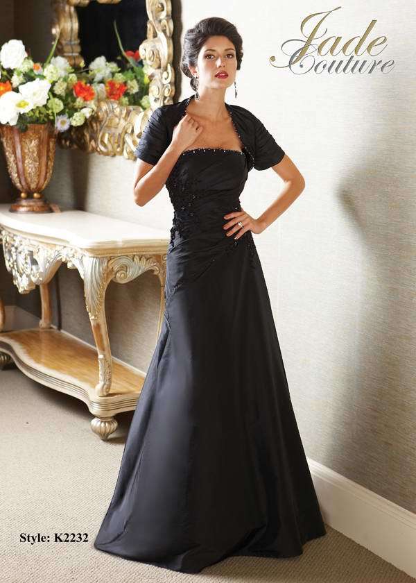 Mother of the Bride Dress: JADE COUTURE - K2232  Catalogue Color:  BLACK (BK)  Silhouette:  Luxe Taffeta gown has straight beaded neckline and bodice with drop waist. A-line skirt has side gathering. Matching gathered jacket with beaded neckline.  Fabric-top layer:  LUXE TAFFETA  Accessory:  Jacket and straps  Skirt Length:  Floor  Size Range:   2-26  