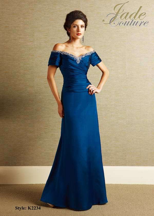 Mother of the Bride Dress: JADE COUTURE - K2234  Catalogue Color:  NIGHT BLUE (NB)  Silhouette:  Jade Silk Dupioni gown has off the shoulder short sleeves with gathers. Shirred bodice has beaded/embroidered neckline and a drop waist. A-line skirt.  Fabric-top layer:  SILK DUPIONI  Accessory:  N/A  Skirt Length:  Floor  Size Range:   2-26  