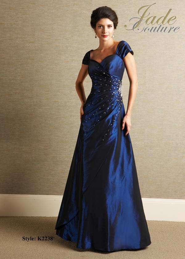 Bridesmaids Dress: JADE COUTURE - K2238  Catalogue Color:  NAVY (NY)  Silhouette:  Luxe Taffeta gown has sweetheart neckline with gathered cap sleeves. Bodice has side gathers with beaded details and drop waist. A-line skirt has assymmetrical overlay.  Fabric-top layer:  LUXE TAFFETA  Accessory:  N/A  Skirt Length:  Floor  Size Range:   2-26  