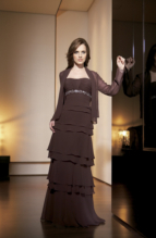 Evening Dress: JADE - J1171  Catalogue Color :  ESPRESSO (EO) Silhouette :  Jade Chiffon gown has horizontal shirring with vertical center shirred bodice; empire waistline has beaded trim with center front crystal applique. A-line skirt has layered tiers; matching jacket has long sleeves and pointed front ends.Fabric-top layer :  JADE CHIFFONGown or 2 piece :  DressJacket :  Front Neckline :  StraplessBack Neckline :  StraplessFront Bodice Detail :  Beaded embroidery and gatheredBack Bodice Detail :  Beaded embroidery and gatheredSleeve :  Gown :  Belt or Sash Detail :  N/AWaist :  EmpireFront Skirt Detail : LayersBack Skirt Detail :  LayersFront Hem Detail :  PlainBack Hem Detail :  PlainAccessory :  Jacket and strapsSkirt Length :  FloorSize Range :  2-26 