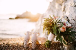 bridal shoes with rhinestones heels standing sea pebble beach bridal bouquet