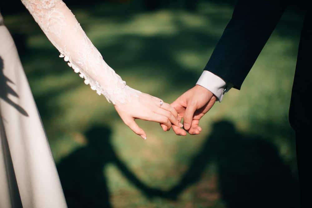 Couple holding hands newlyweds