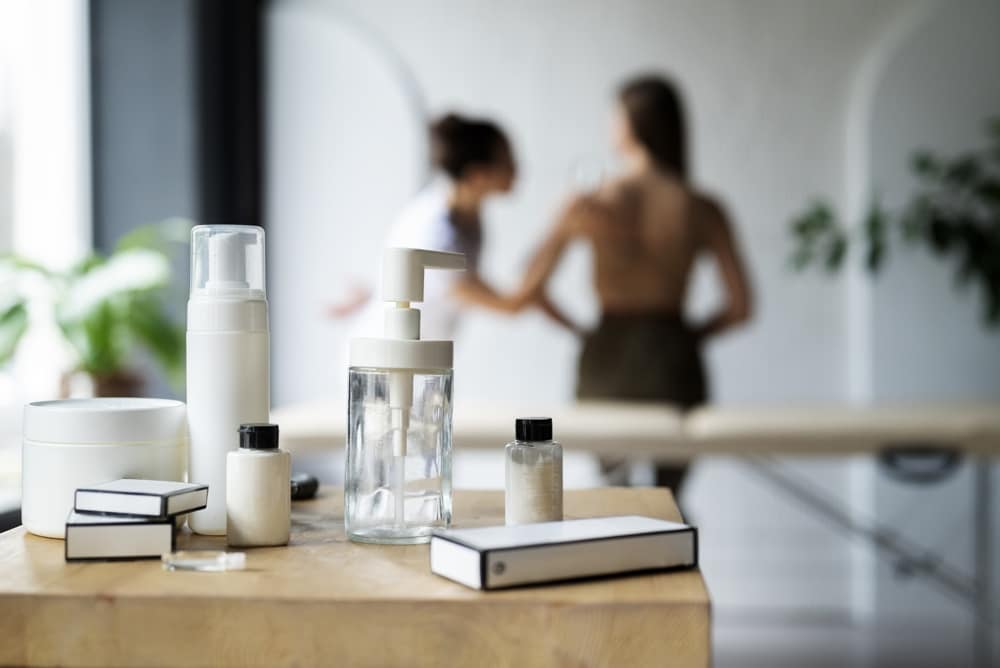 Four-step balm routine for mature skin on a dresser beside a mother of the bride dress, Frøya Organics